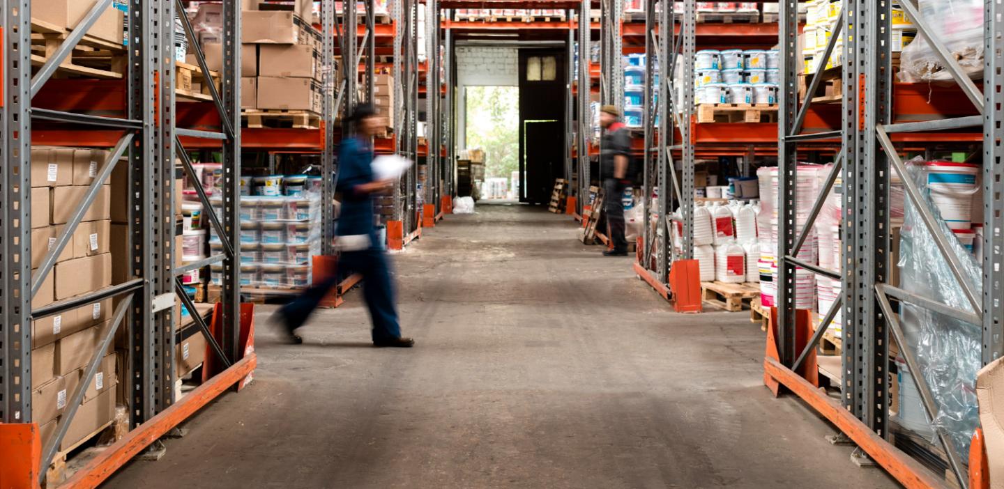 Busy warehouse with employees moving