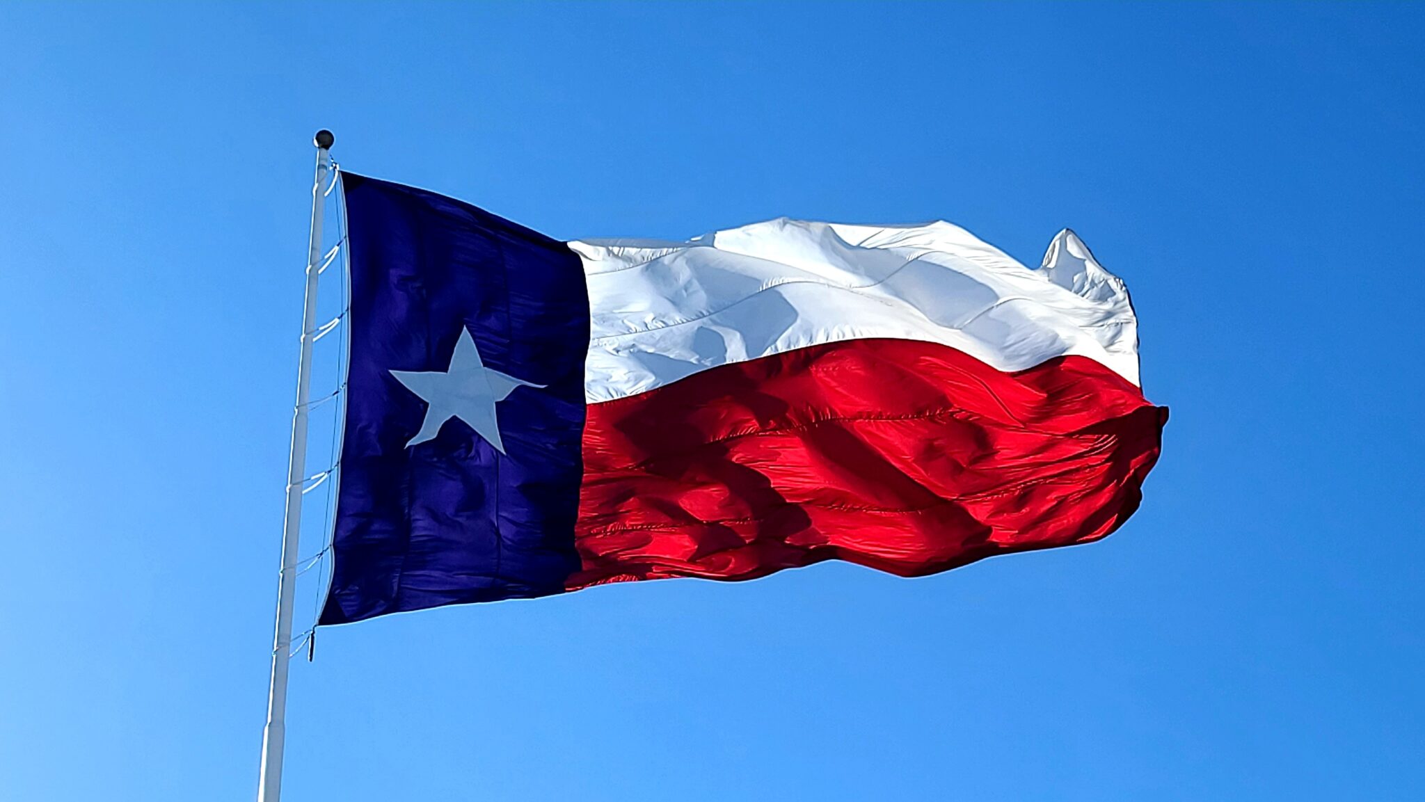 Insights Blog 5 Texas flag waving in blue sky