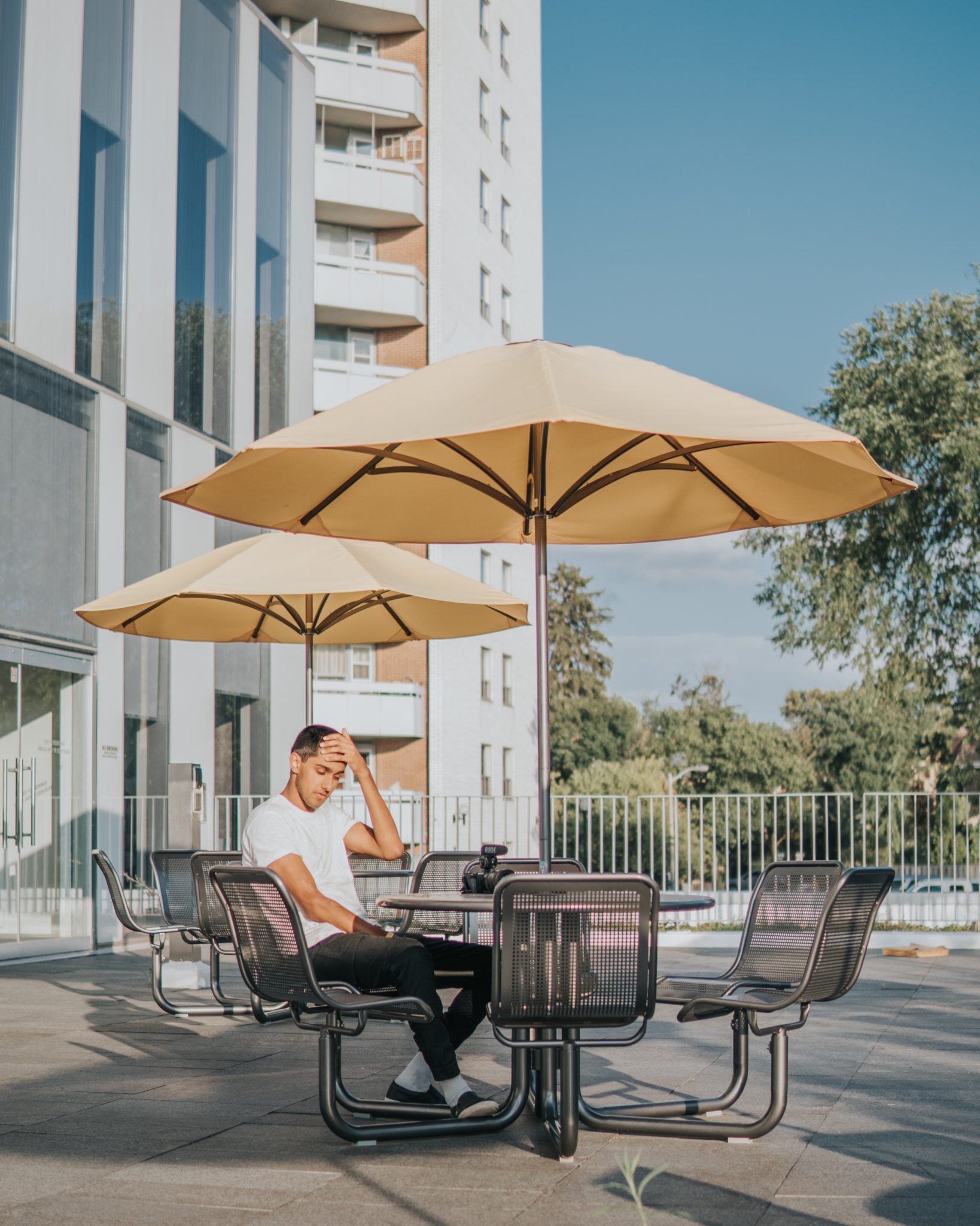Insights Blog 9 Man sitting under large umbrellas outdoors