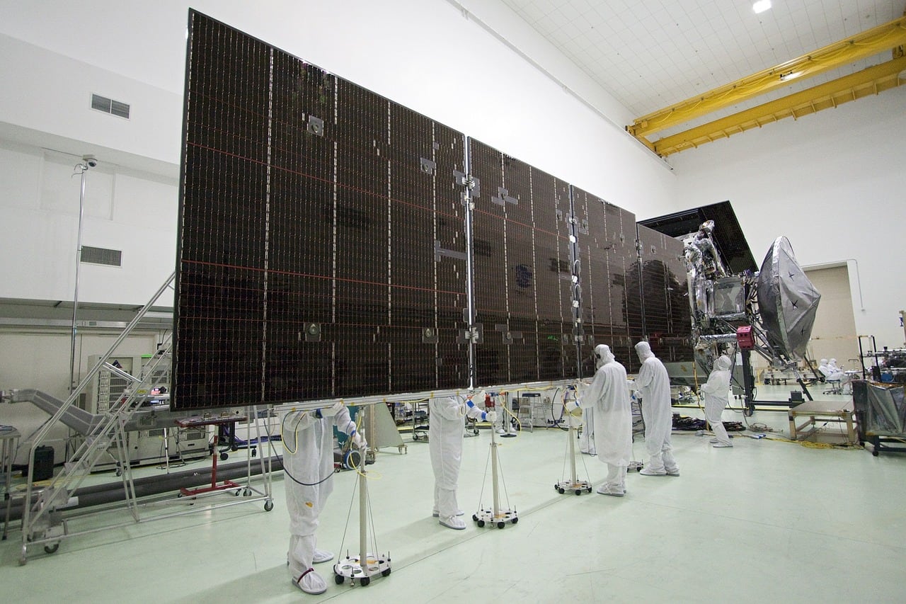Insights Blog 9 Large solar panels being assembled indoors.