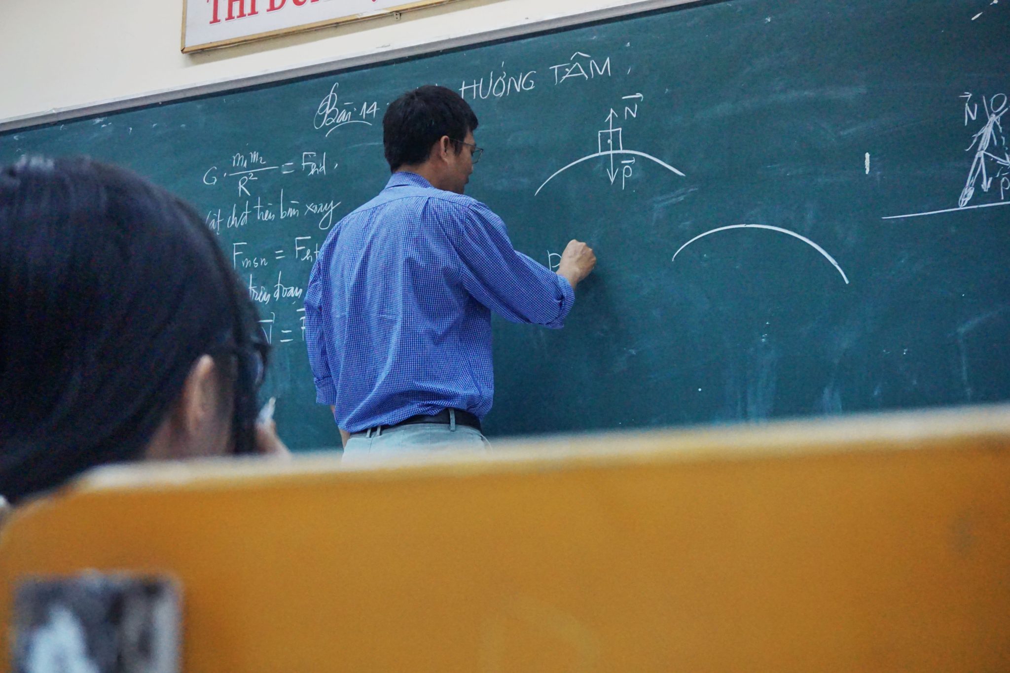 Insights Blog 3 Teacher explaining physics on chalkboard