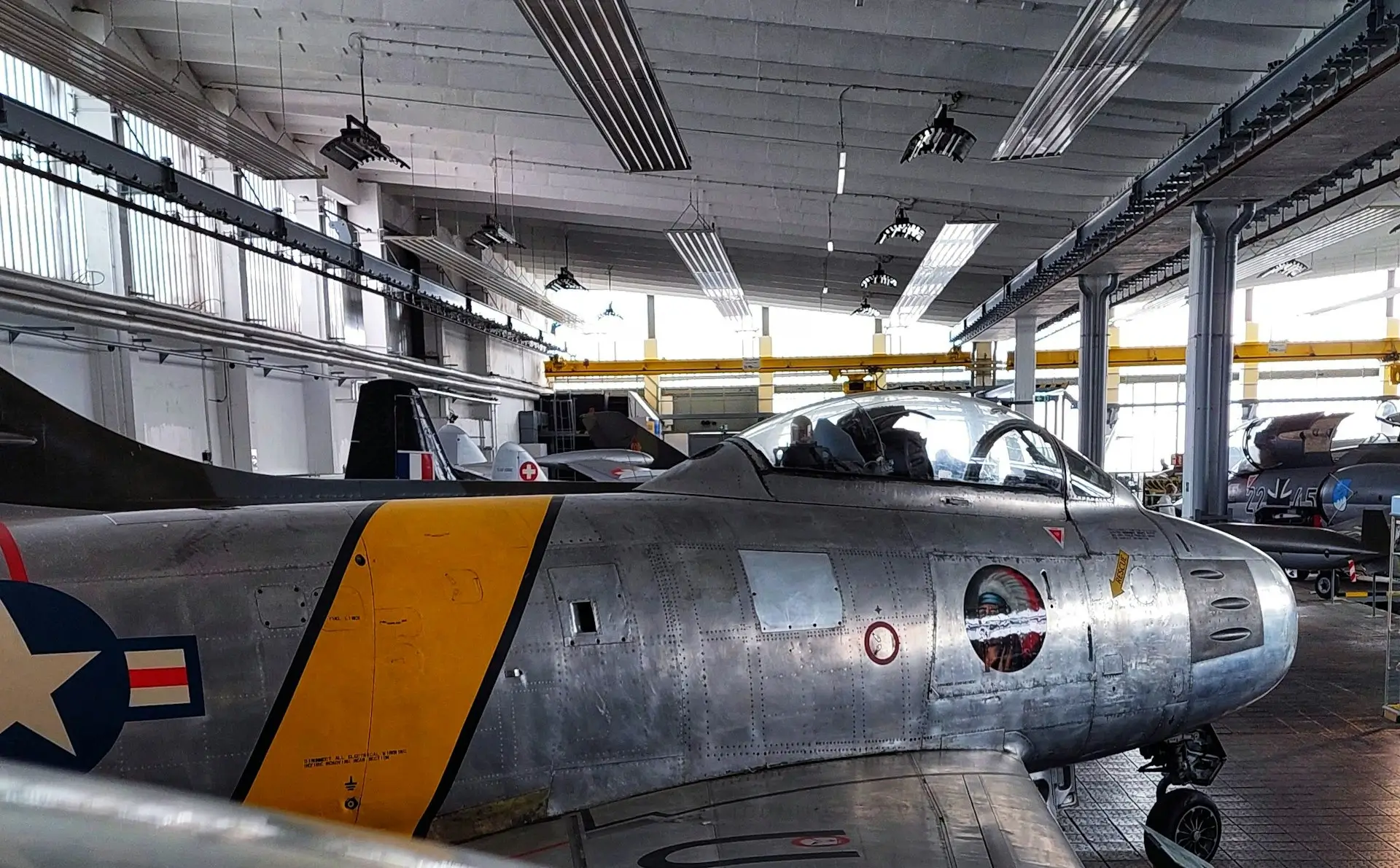 Insights Blog 3 Military jet aircraft inside an aircraft hangar.