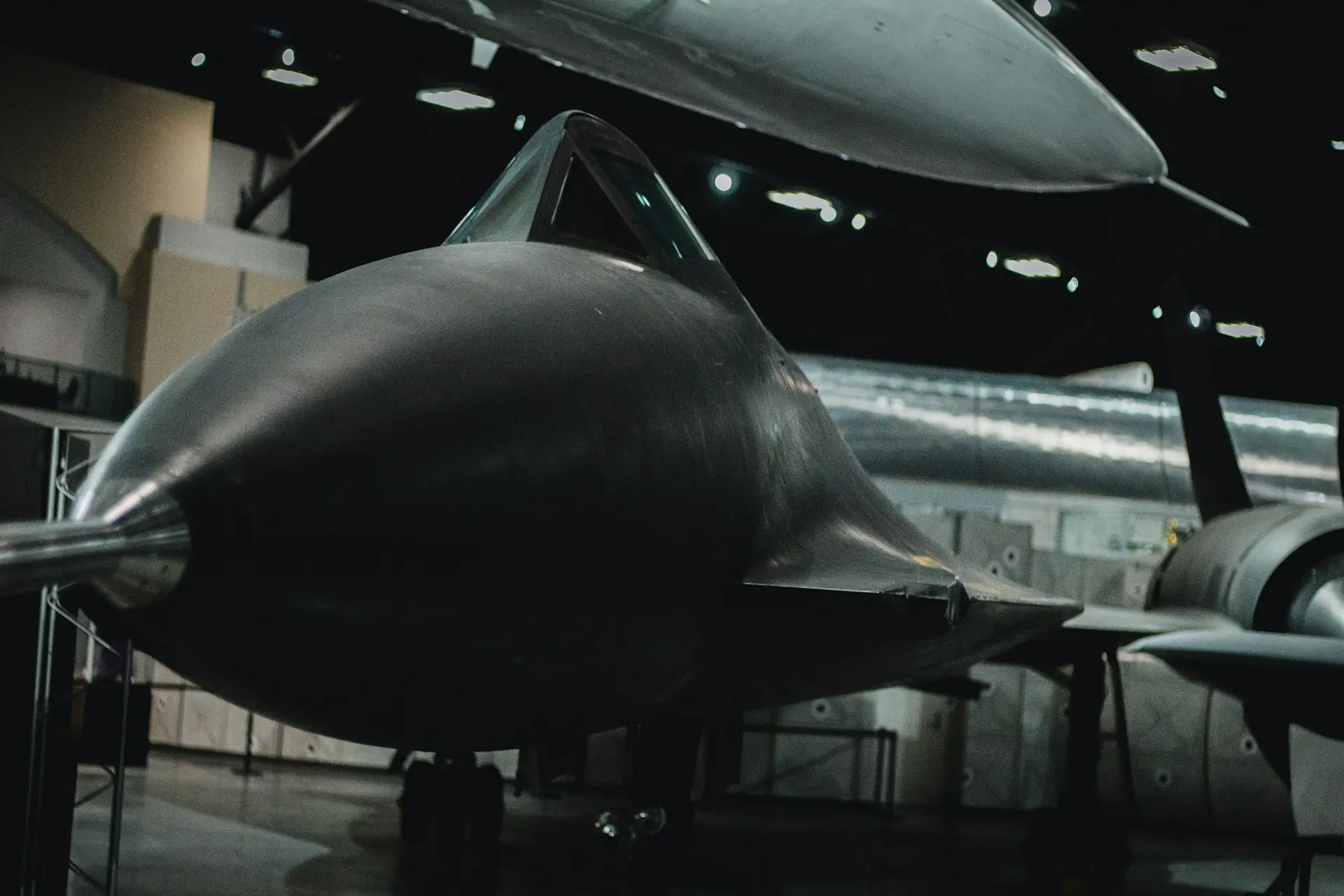 Insights Blog 1 Front view of a stealth reconnaissance aircraft displayed inside an aerospace facility.