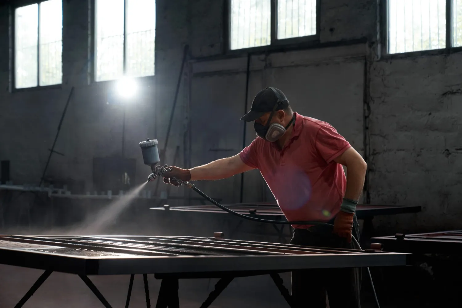 Insights Blog 9 Operator spray painting metal structure