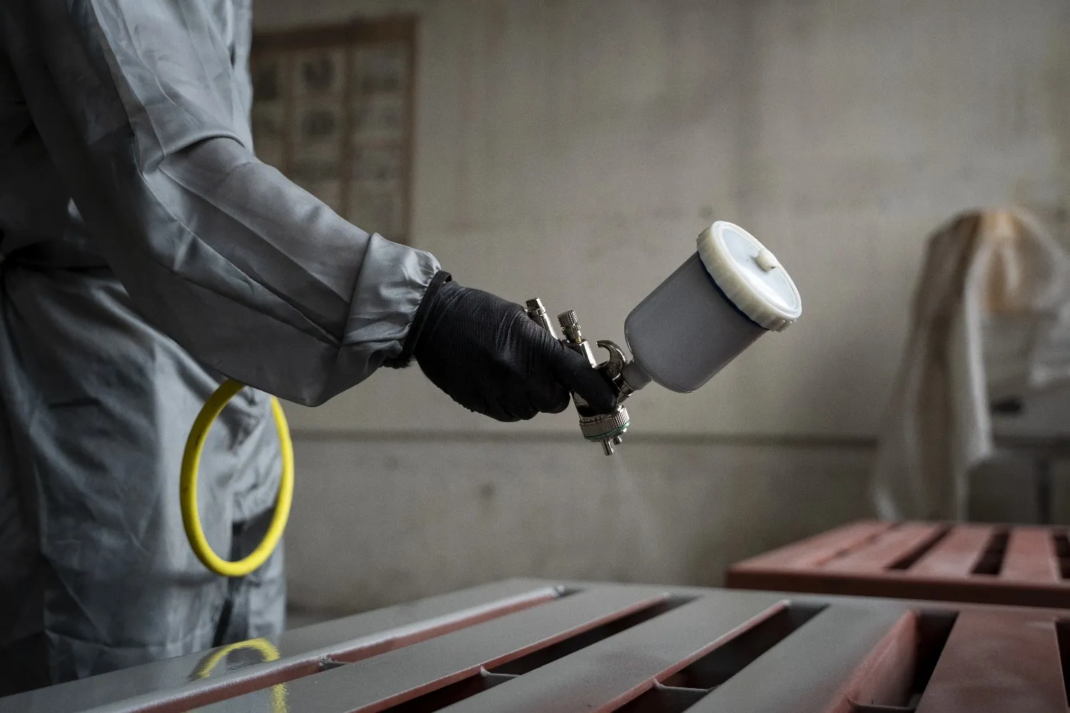 Insights Blog 7 Technician spray painting metal surface