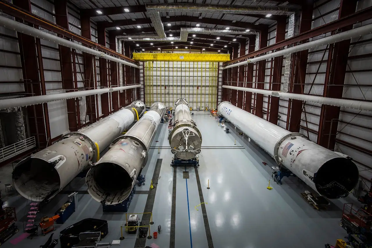 Aerospace manufacturing facility with rocket components in controlled environment hangar
