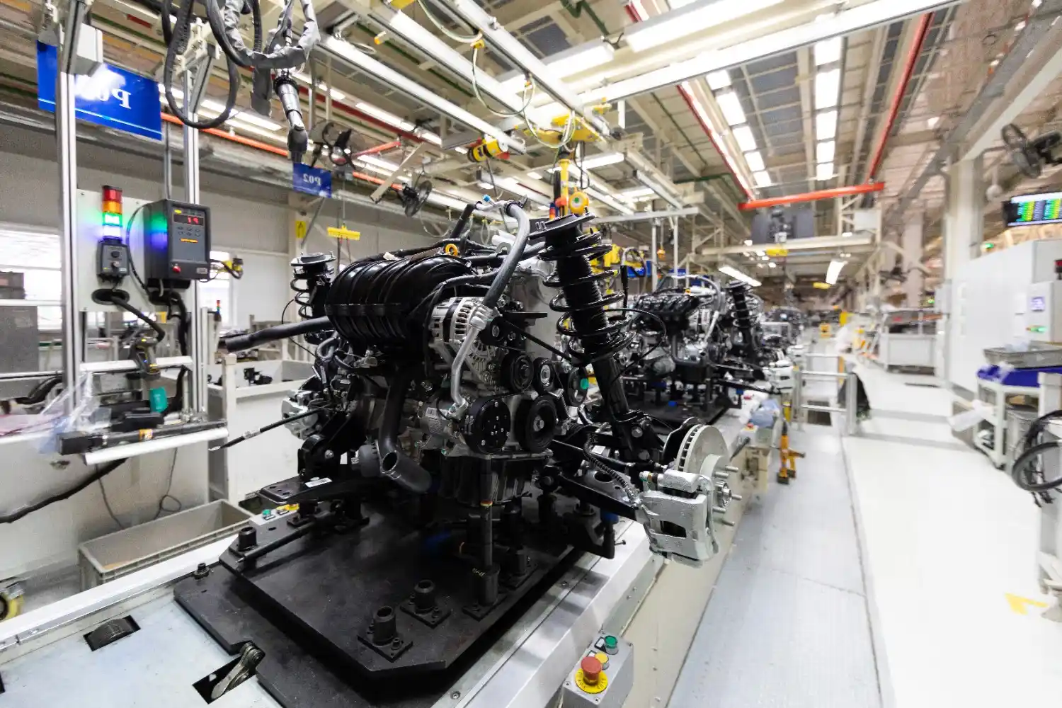 Insights Blog 9 Automotive manufacturing line assembling engine components in a factory, illustrating environments where humidity control systems support production quality.