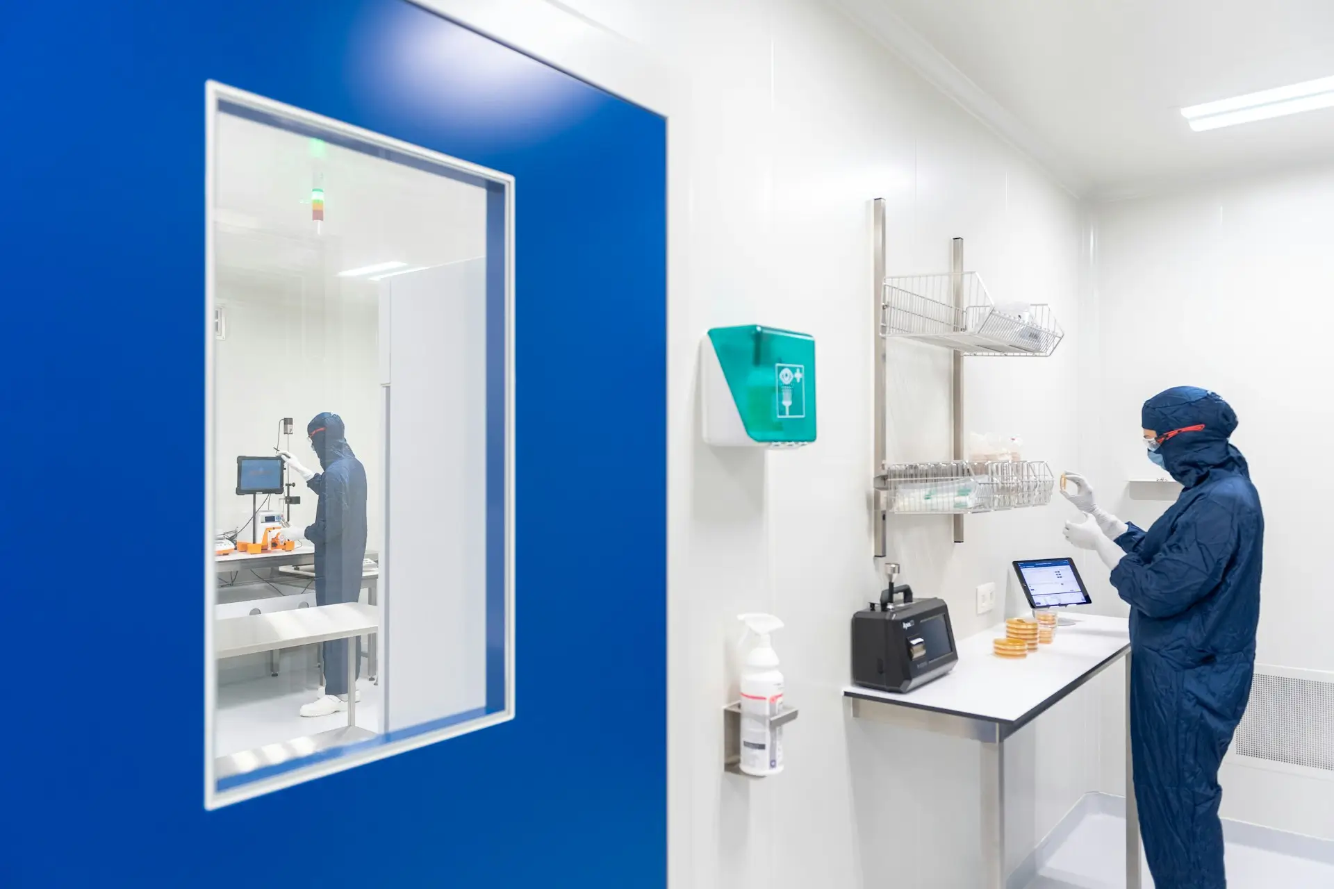 Insights Blog 5 Cleanroom environment with technicians working and monitoring conditions, illustrating selection and operation of humidity control systems.