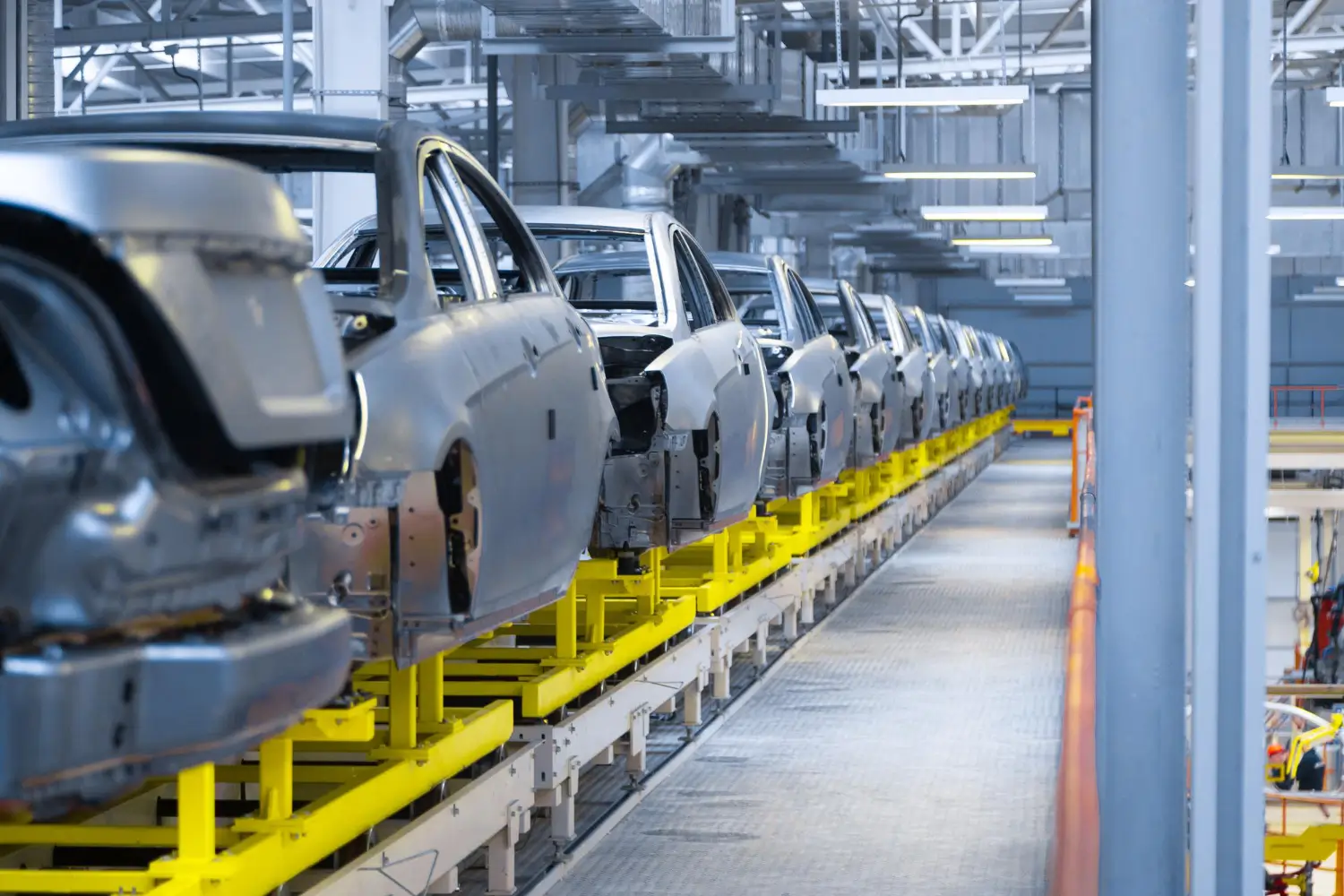 Insights Blog 6 Automotive assembly line with car bodies moving through a production facility, illustrating environments where humidity control supports manufacturing quality.