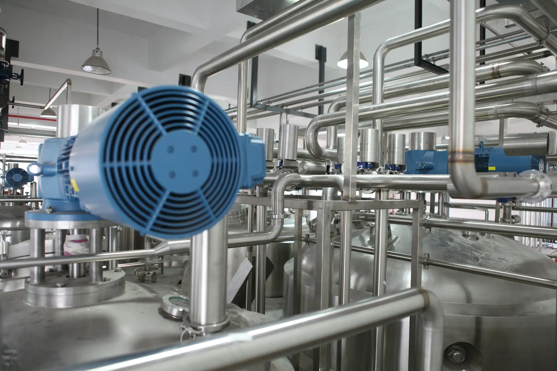 Industrial equipment with stainless steel piping and motor system in a controlled environment