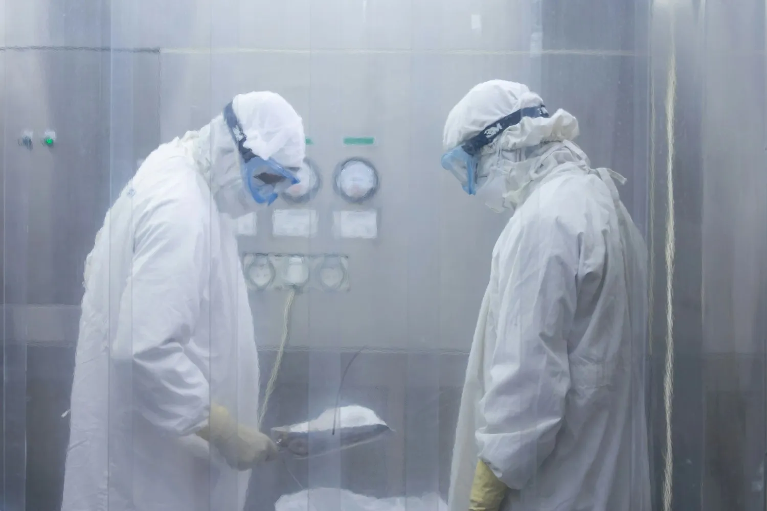 Insights Blog 3 Two technicians in full protective cleanroom suits working in a controlled industrial environment where precise humidity management is critical to protecting sensitive equipment and processes.