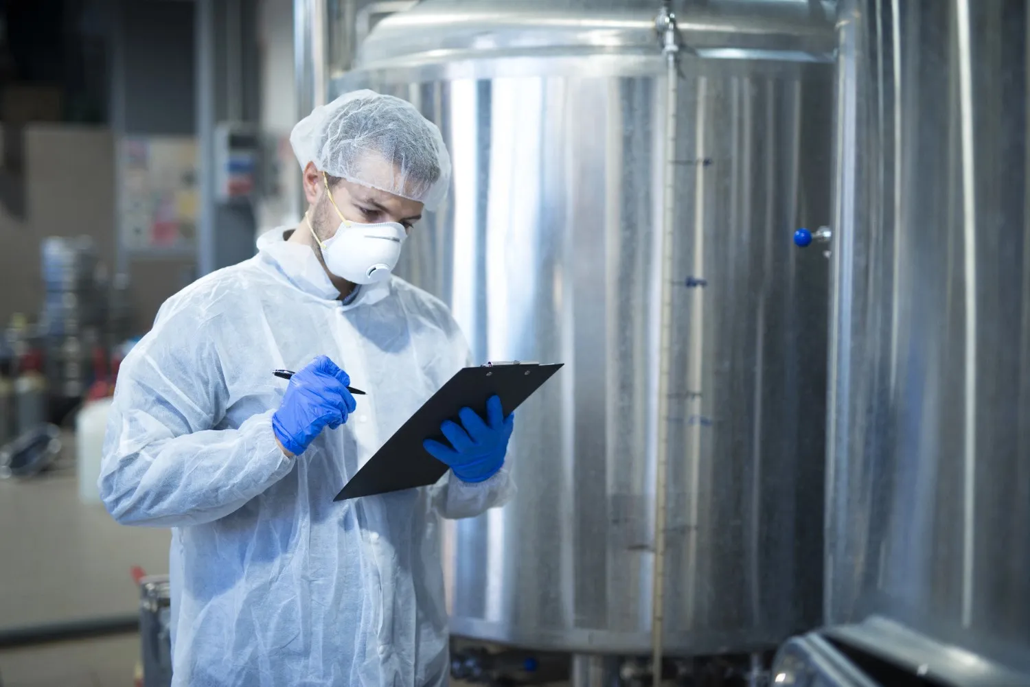 Insights Blog 6 Pharmaceutical technician checking and documenting production conditions, highlighting monitoring practices for maintaining ideal humidity levels and compliance.