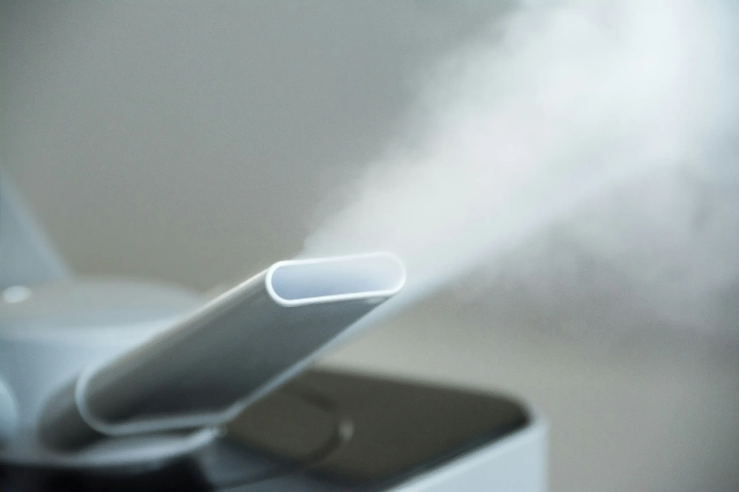 Insights Blog 1 Ultrasonic humidifier releasing a fine cool mist into the air, demonstrating controlled moisture generation for indoor humidity management without visible water droplets or surface wetting.