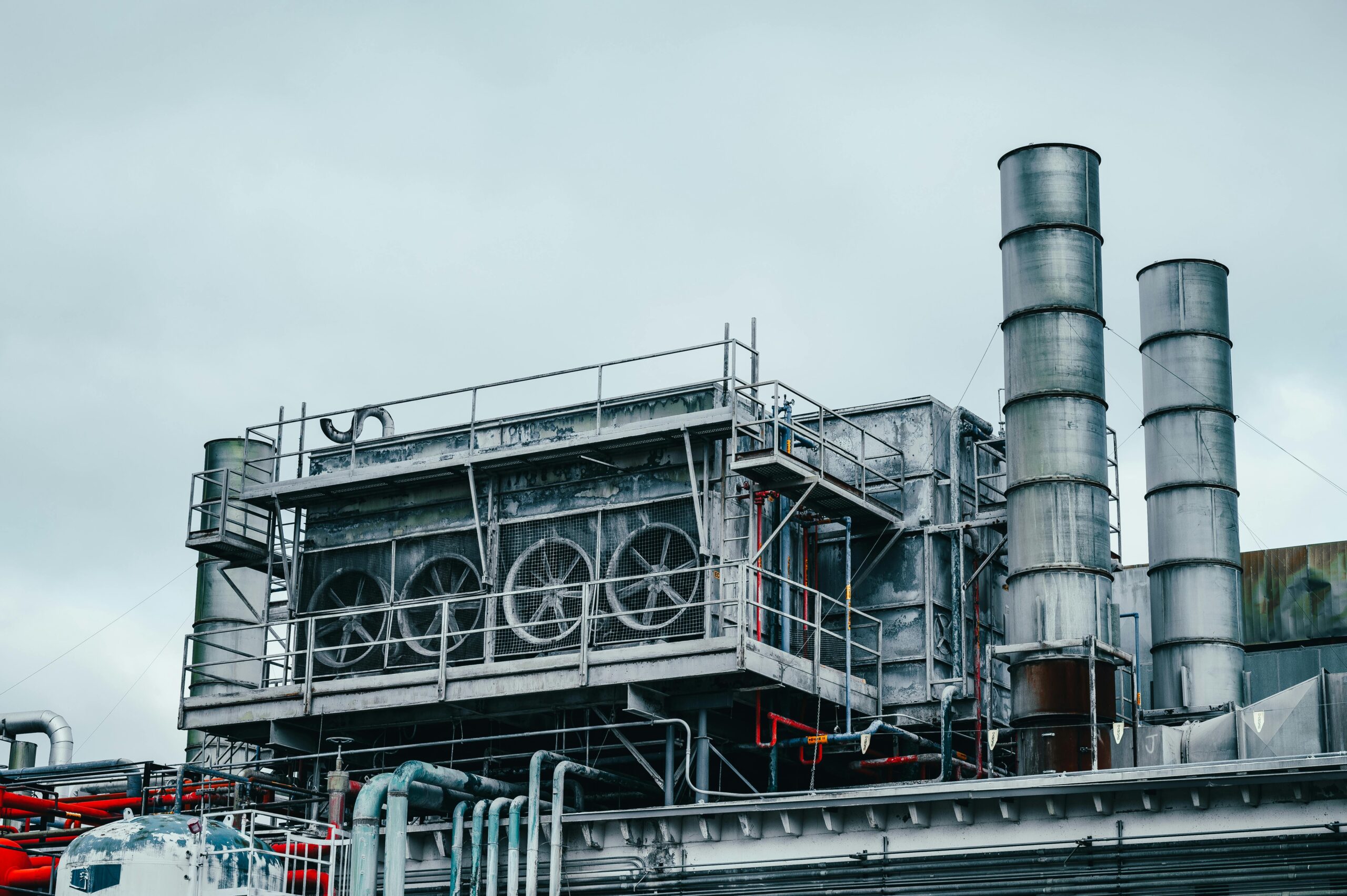 Insights Blog 4 Industrial cooling and air handling equipment with large ventilation fans, ducting, and process infrastructure installed at a manufacturing facility, supporting environmental control and facility operations.