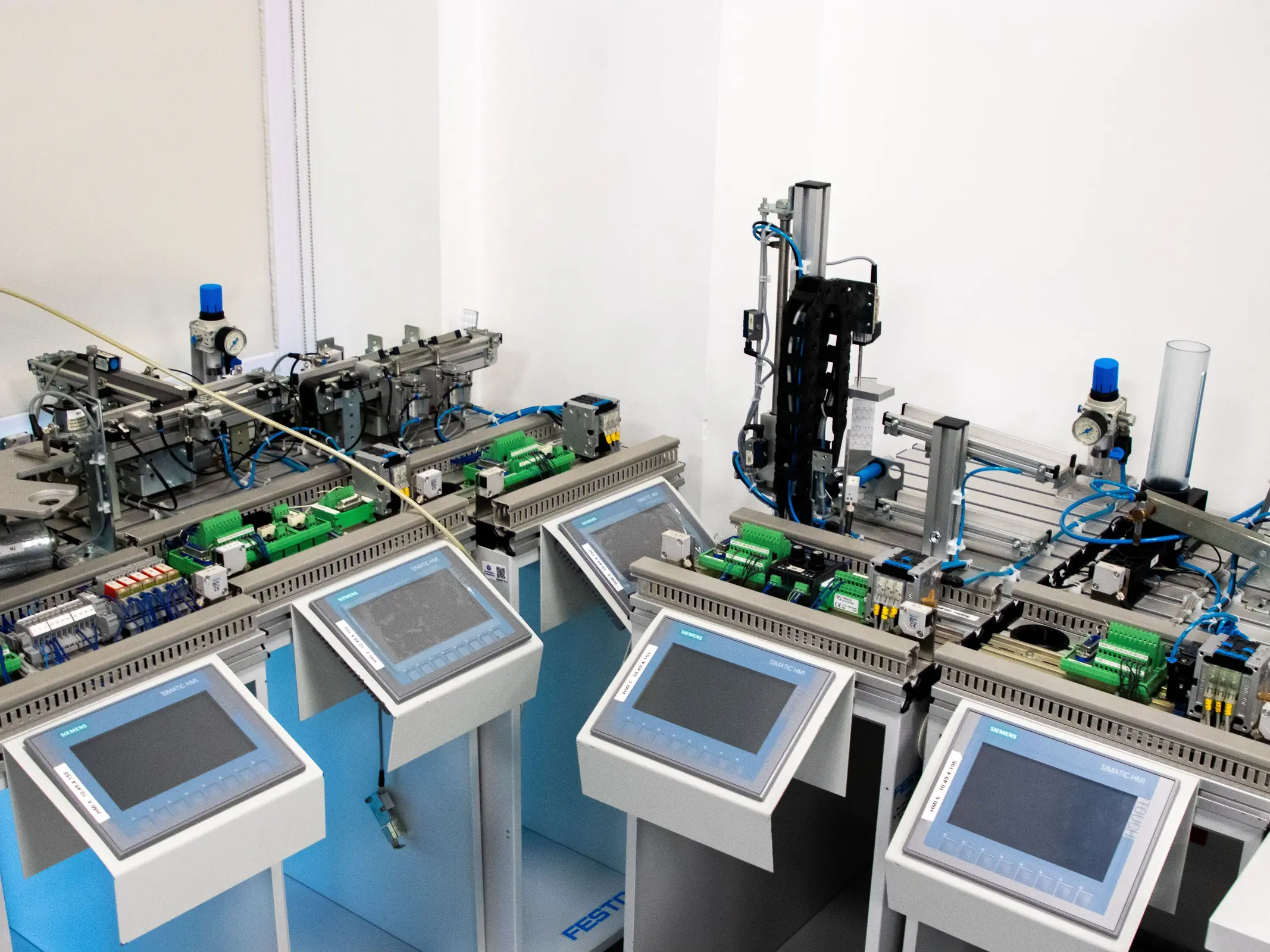 Insights Blog 4 Industrial automation training and control system with programmable logic controllers (PLCs), operator interfaces, sensors, and pneumatic components used for manufacturing process control.