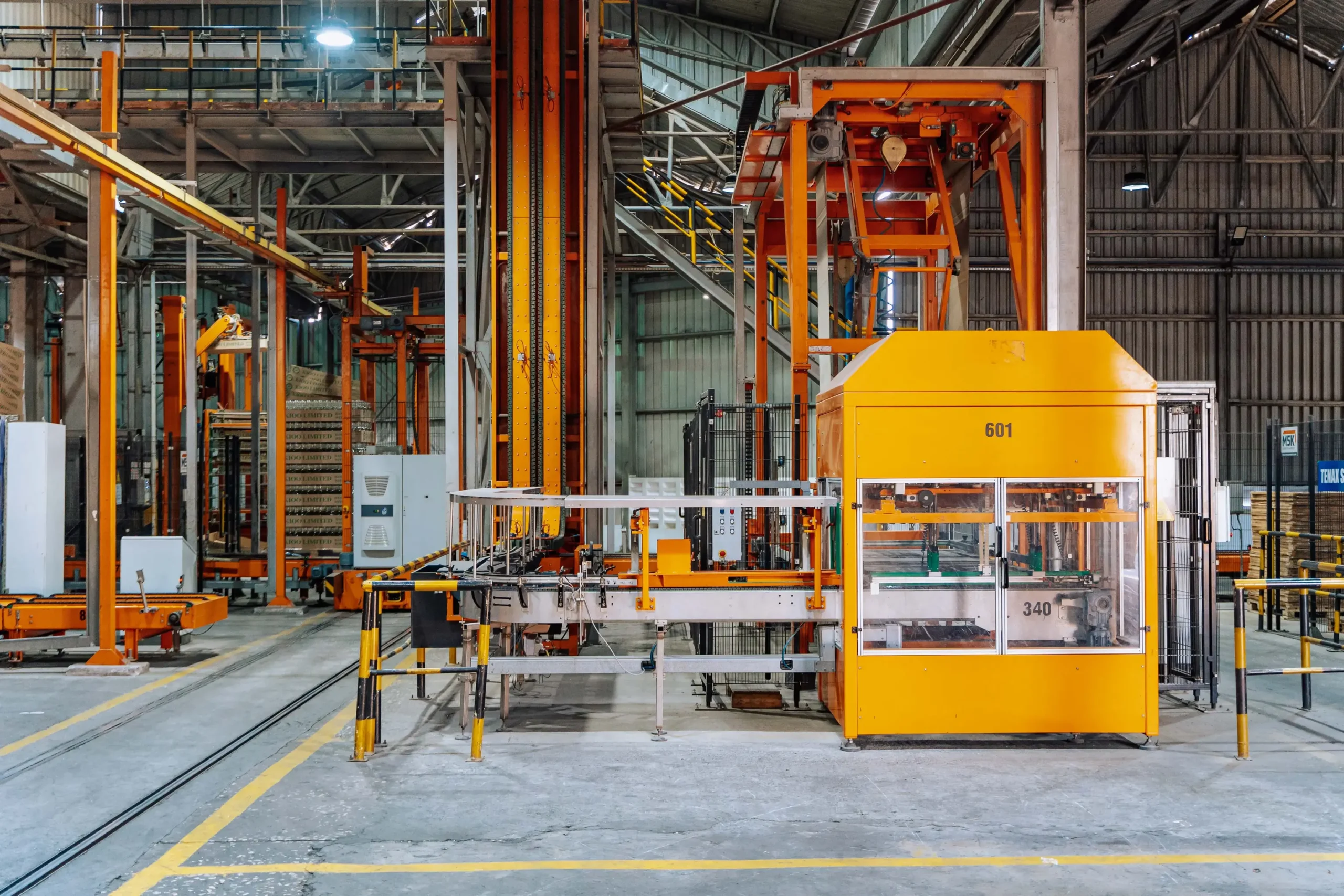 Automated manufacturing production line with industrial machinery, conveyors, and material handling equipment in a large factory facility where static control is critical for operational efficiency and product quality.