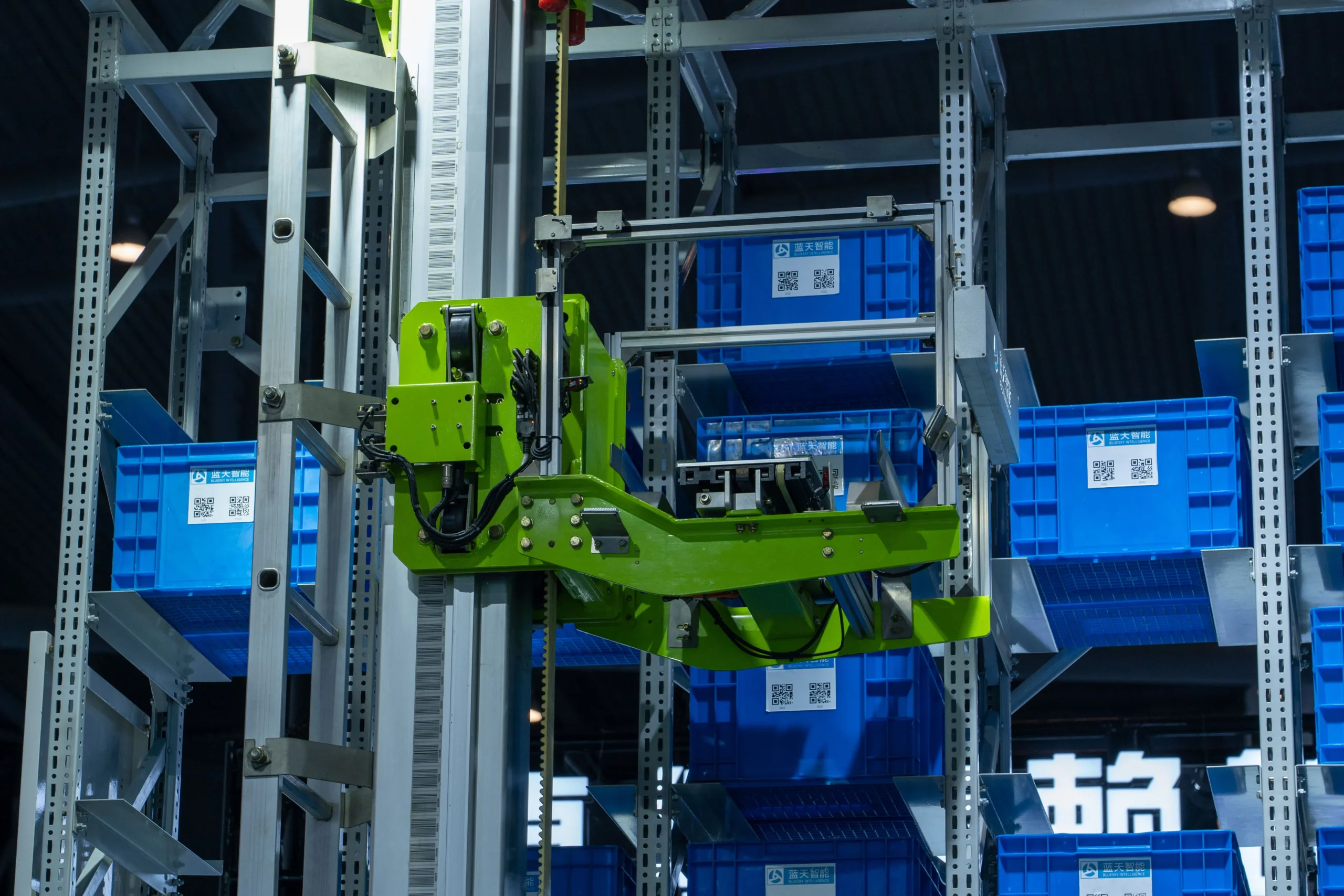 Insights Blog 8 Automated warehouse storage and retrieval system moving inventory bins within a high-density industrial racking environment.