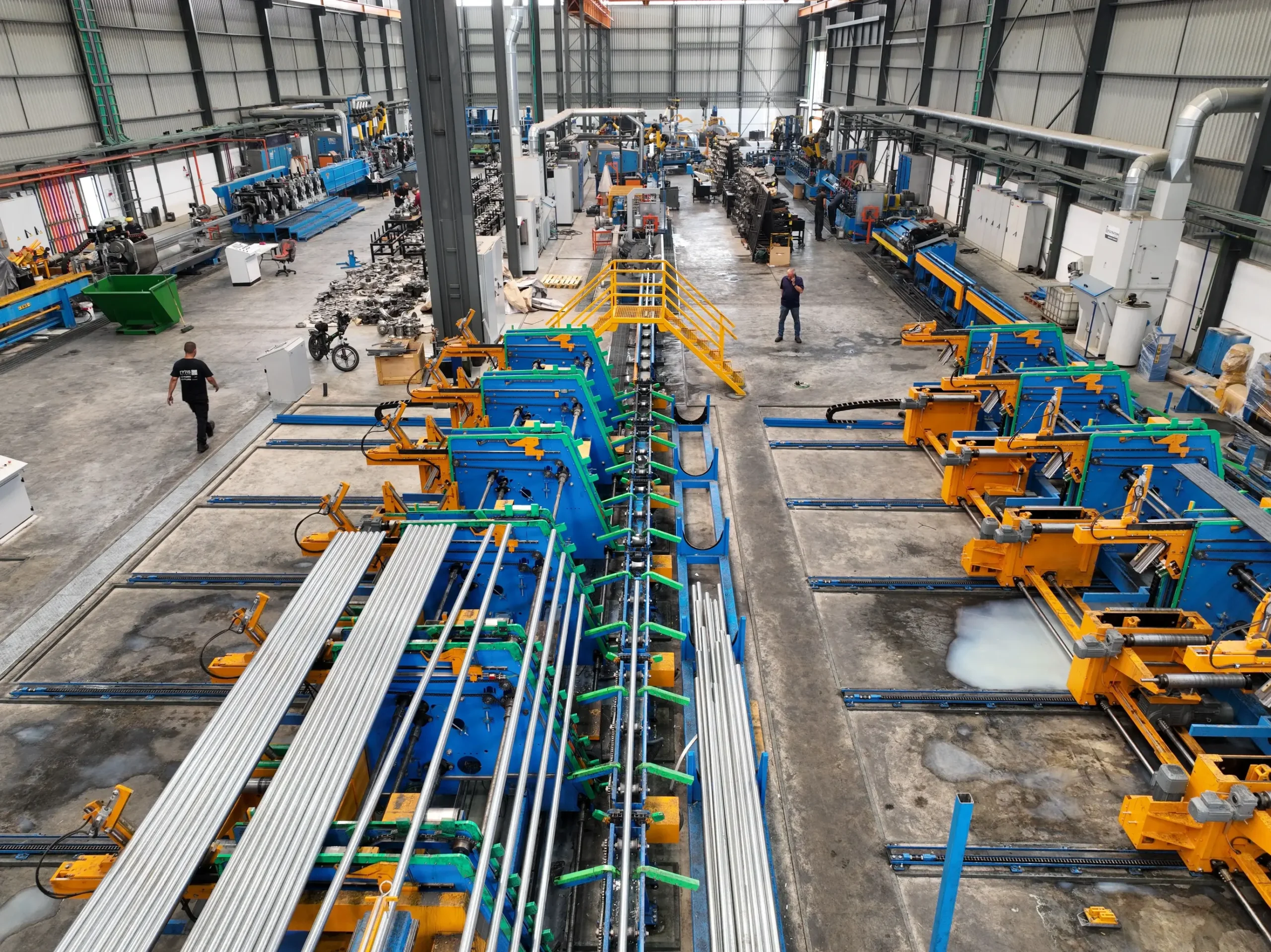 Insights Blog 8 Automated manufacturing facility with industrial production lines processing metal components in a controlled factory environment.
