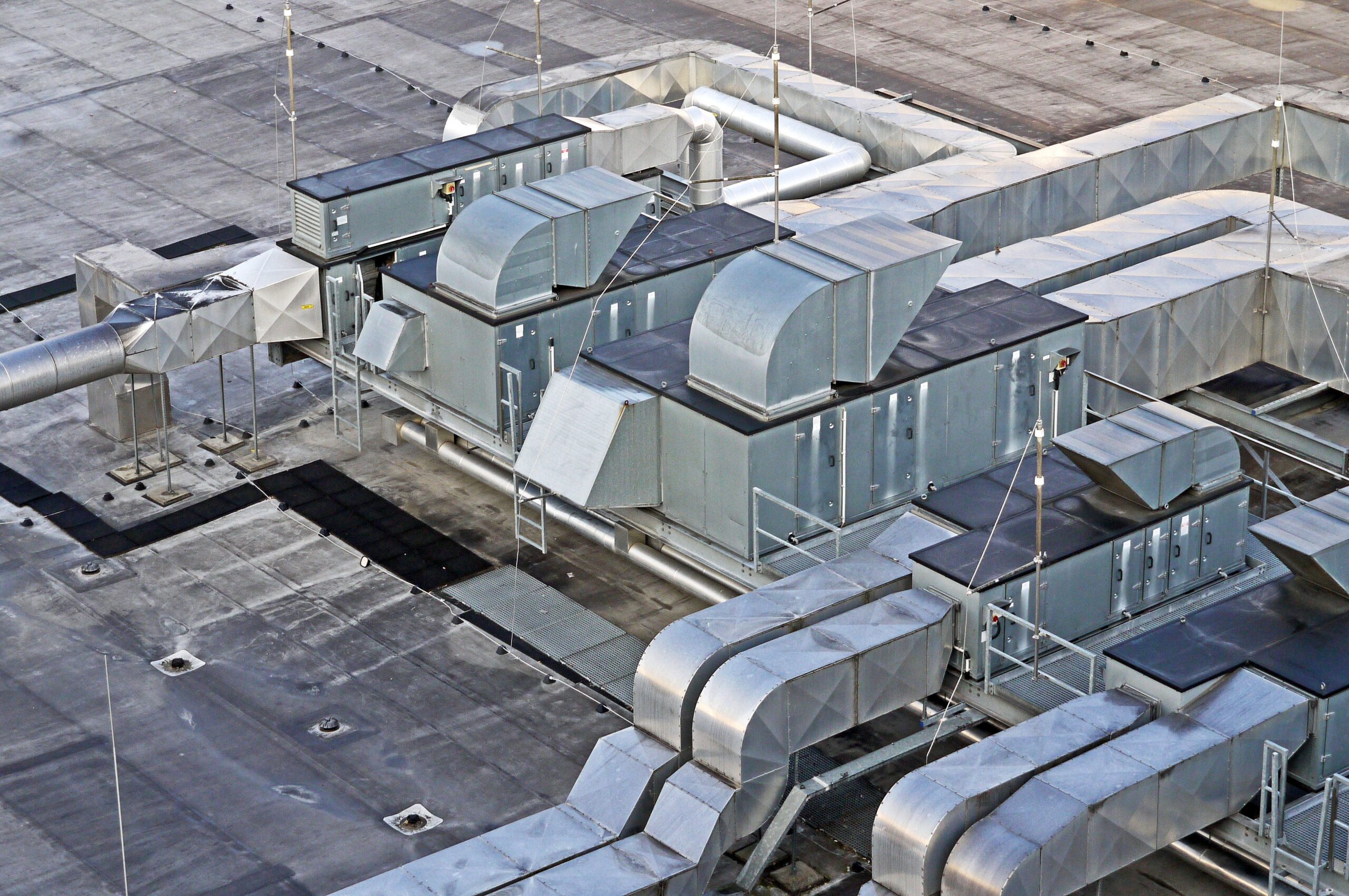 Insights Blog 6 Industrial warehouse ceiling with ventilation systems, representing the airflow and exhaust infrastructure required for evaporative cooling in commercial facilities