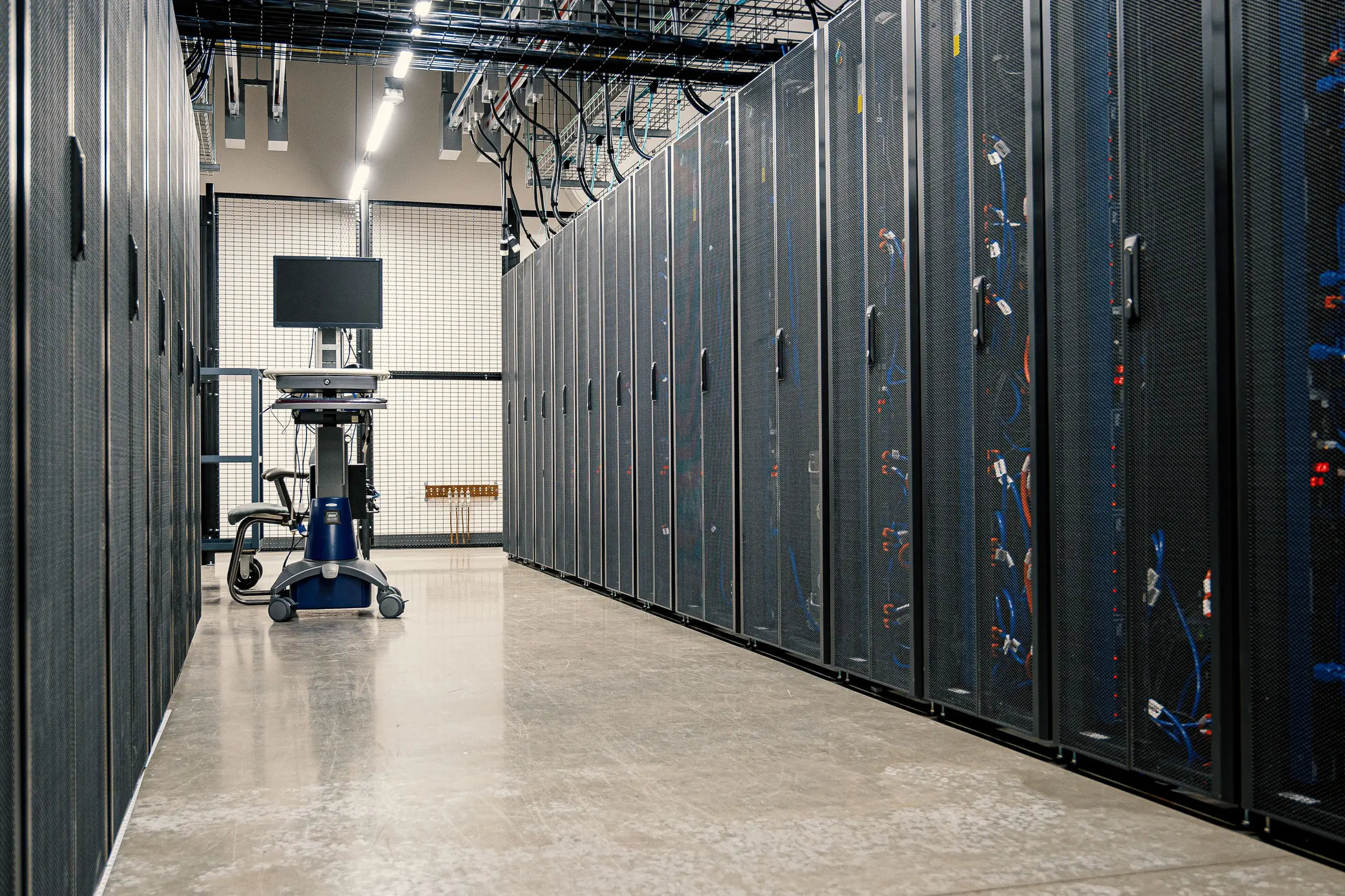Insights Blog 9 Modern data center corridor with server equipment, representing the tightly monitored indoor environments where air quality sensors track ventilation, particulate matter, and humidity