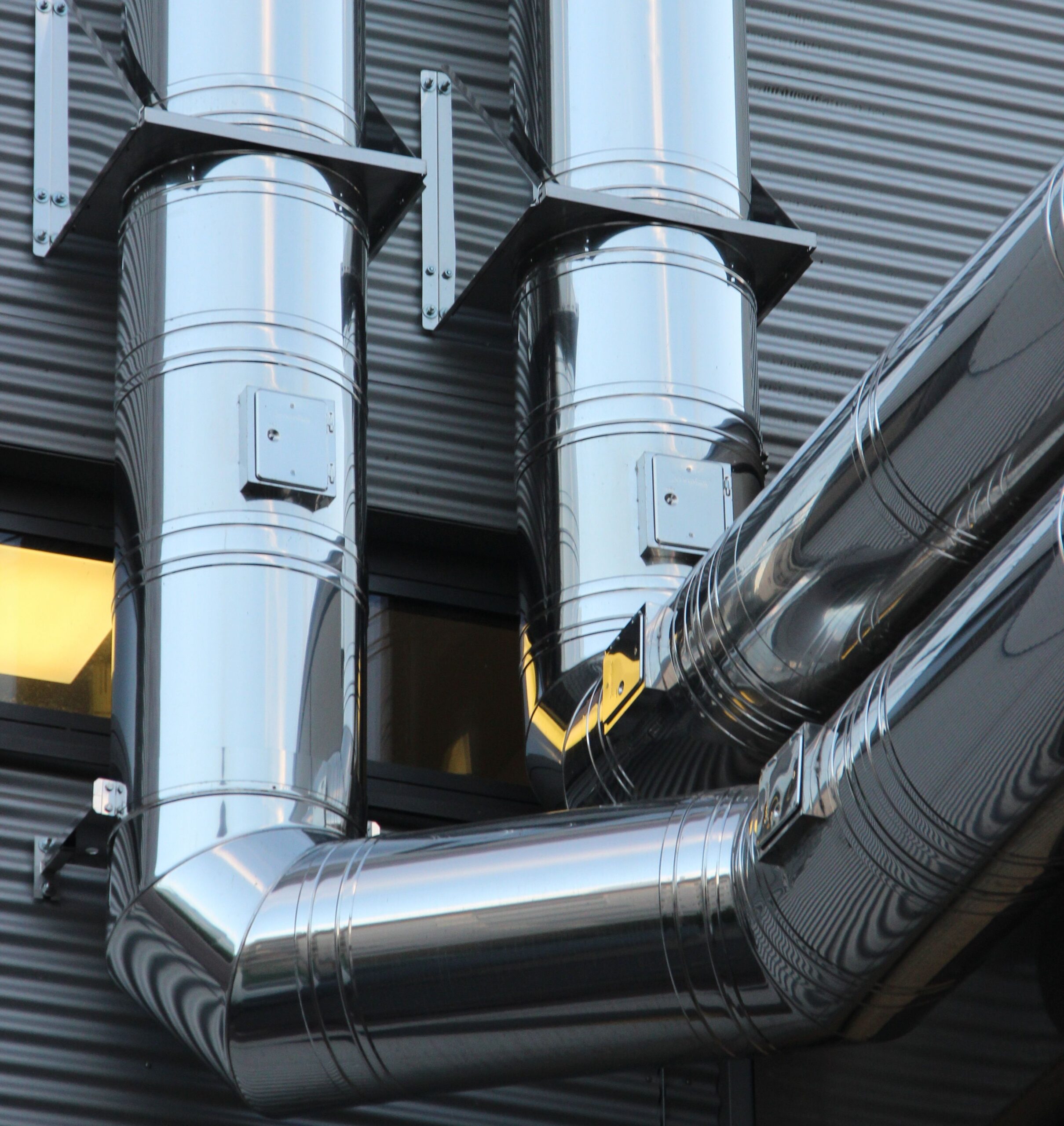 Insights Blog 3 Close-up of industrial steel pipework, representing the cold-surface infrastructure vulnerable to condensation when facility air reaches its dew point