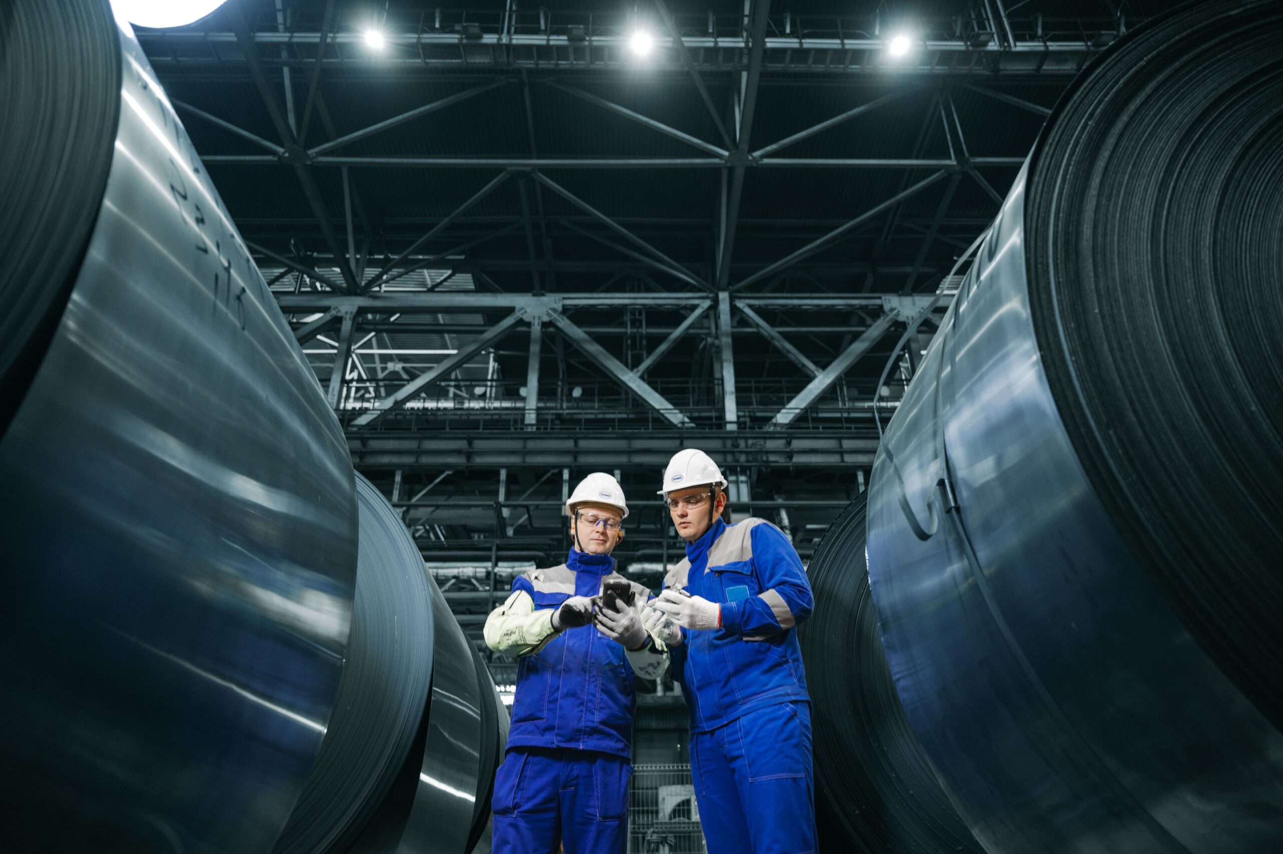Insights Blog 4 Factory workers in safety gear in an industrial facility, representing the workplace environments where static discharge poses both component damage and startle-response injury risks