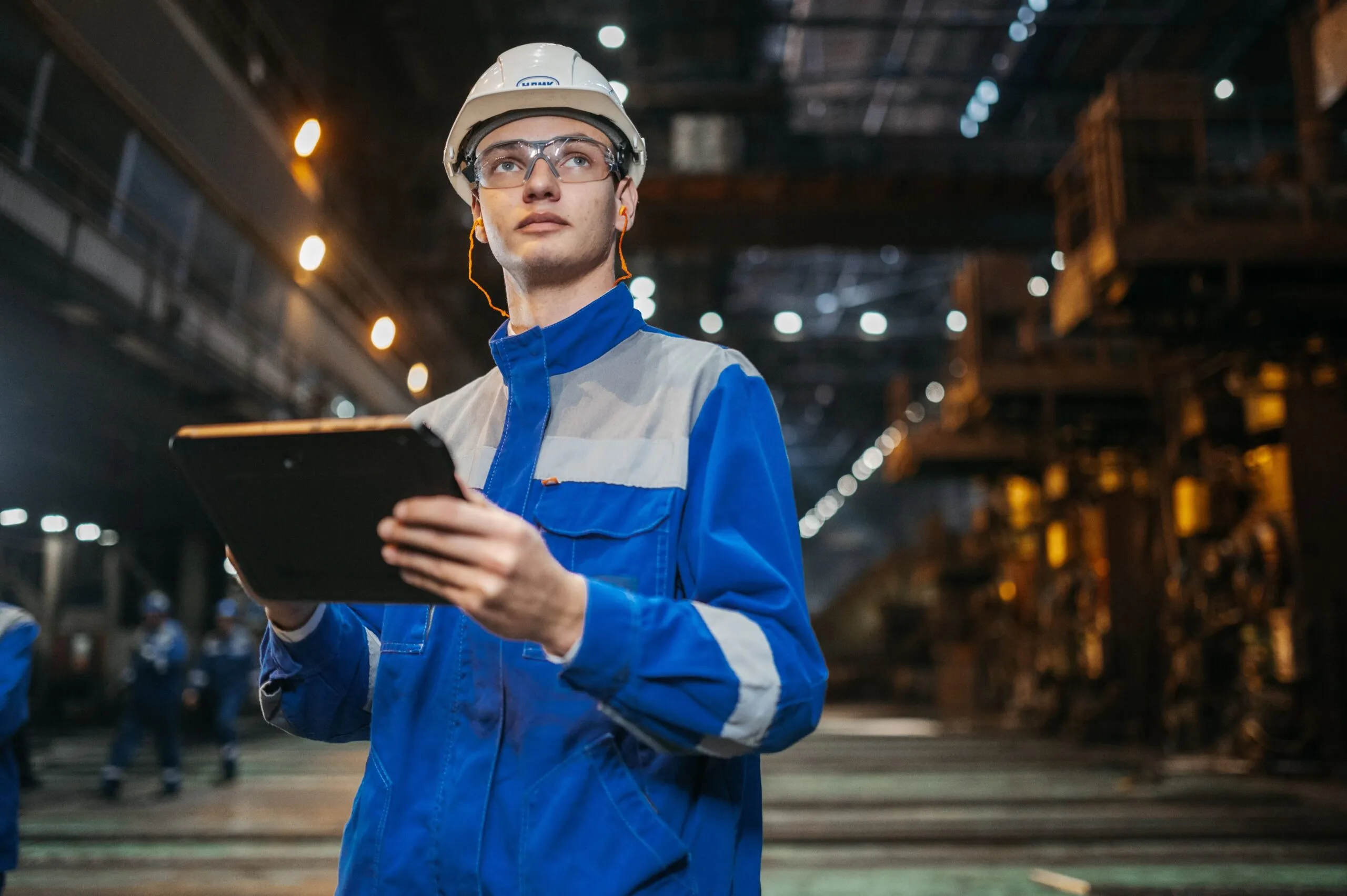 Insights Blog 6 Engineer conducting inspection in an industrial factory setting, representing the verification and testing processes required for ESD control program compliance