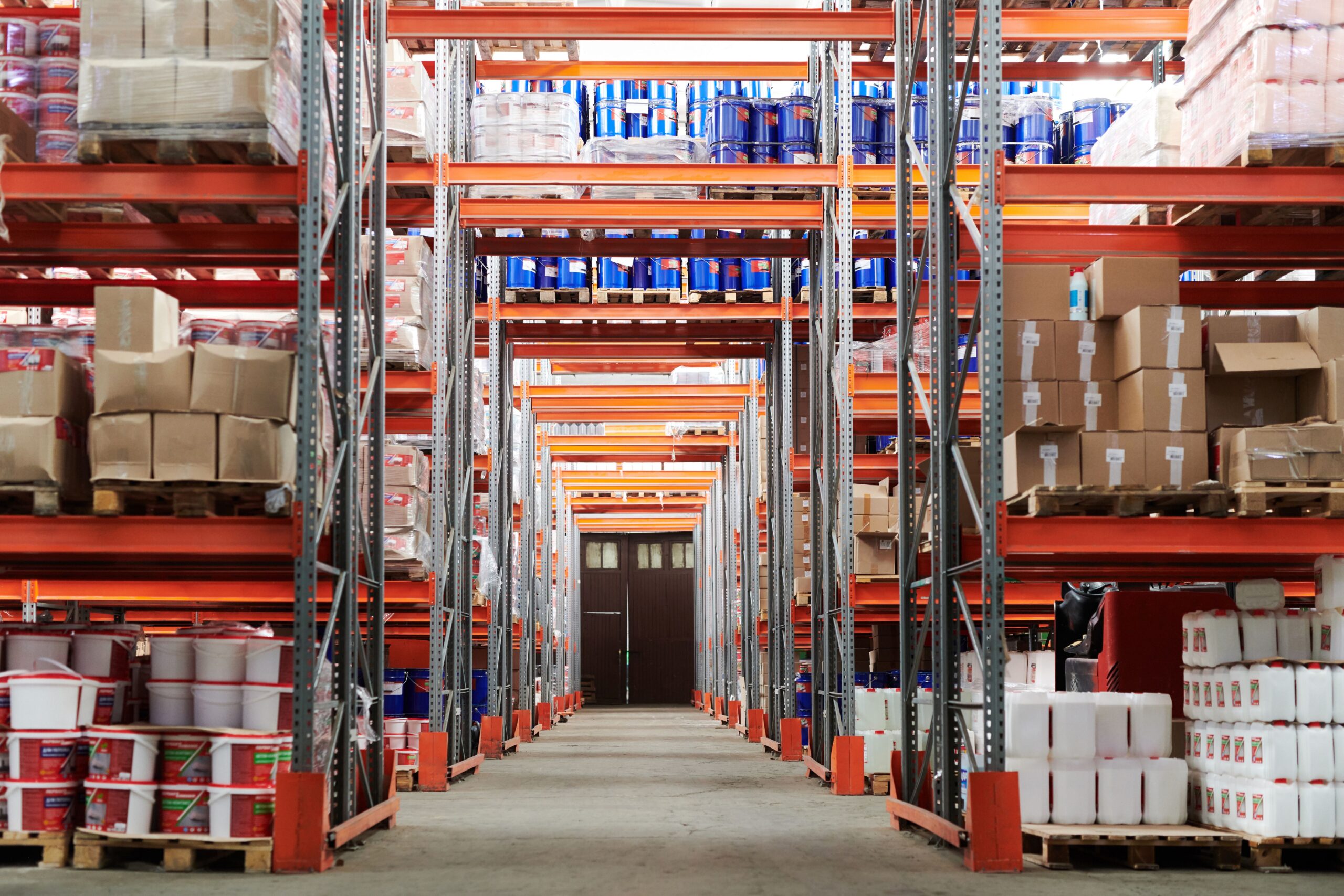 Home Page 4 Interior of a large industrial warehouse with storage shelving, representing the open facility spaces suited to evaporative cooling in dry climates