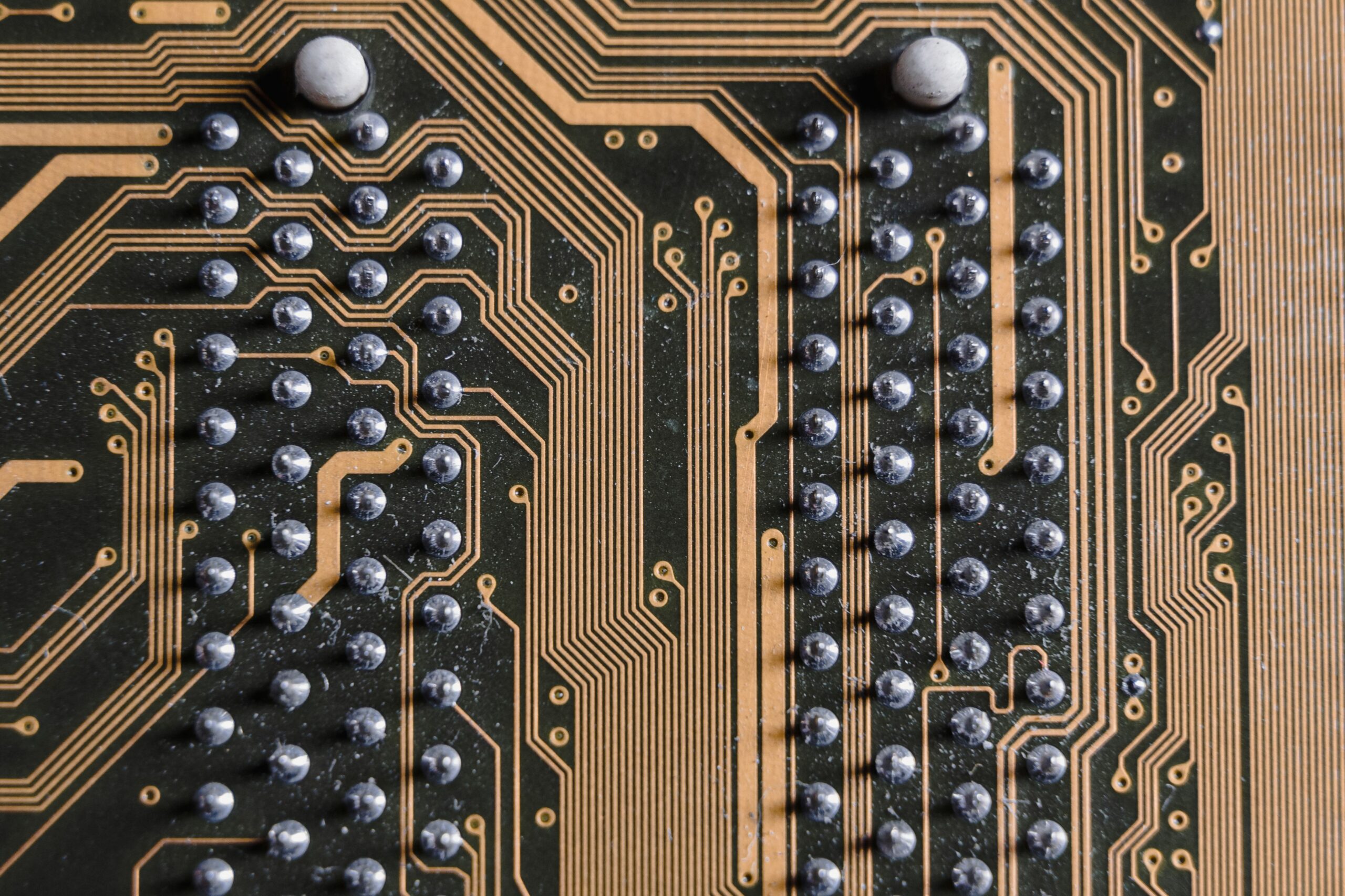 Insights Blog 5 Close-up of solder points on a printed circuit board, representing the ESD-sensitive components that can be damaged at voltages far below what a technician can feel