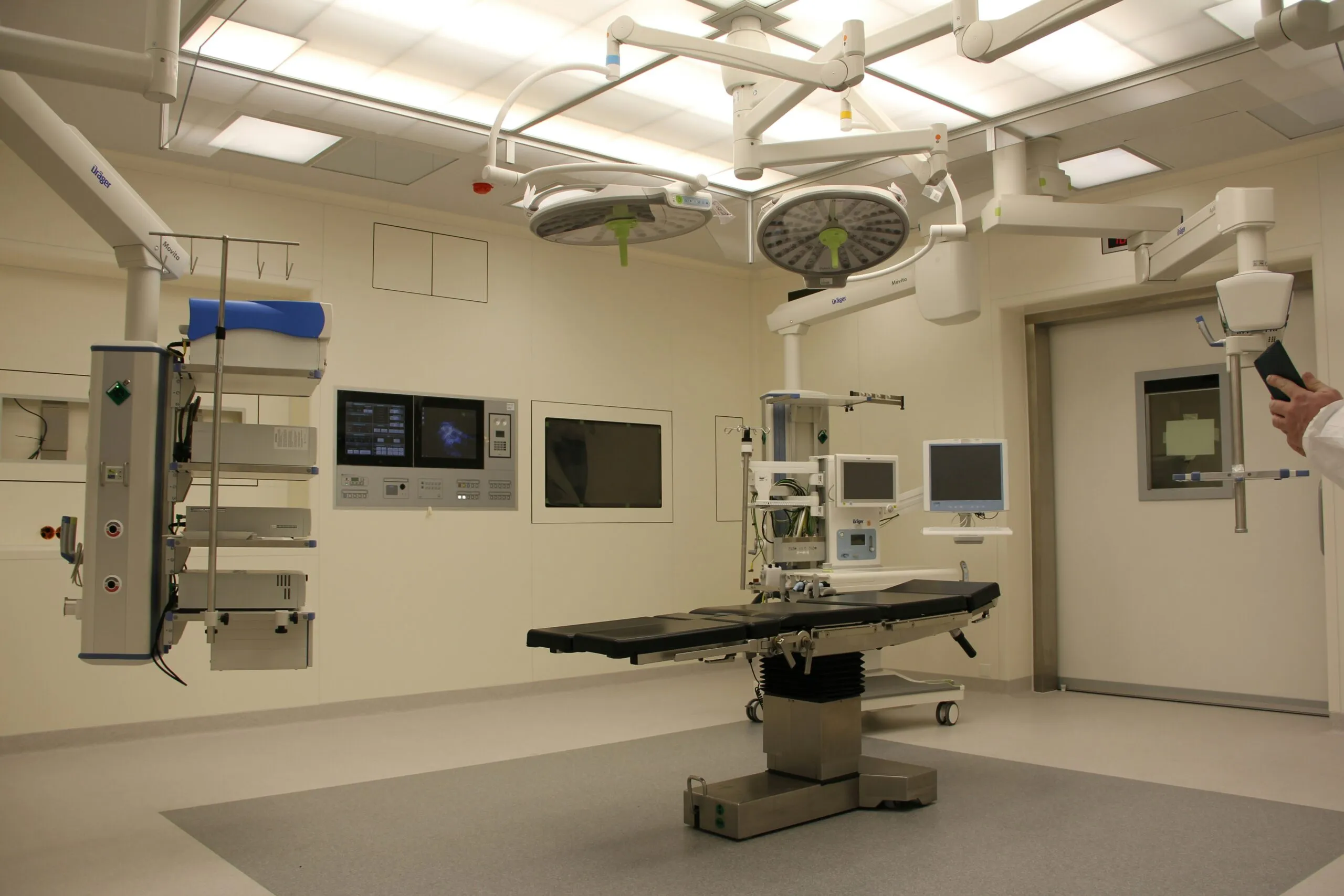 Empty hospital operating room with surgical lighting and monitoring equipment, an environment requiring precise humidity control under ASHRAE 170