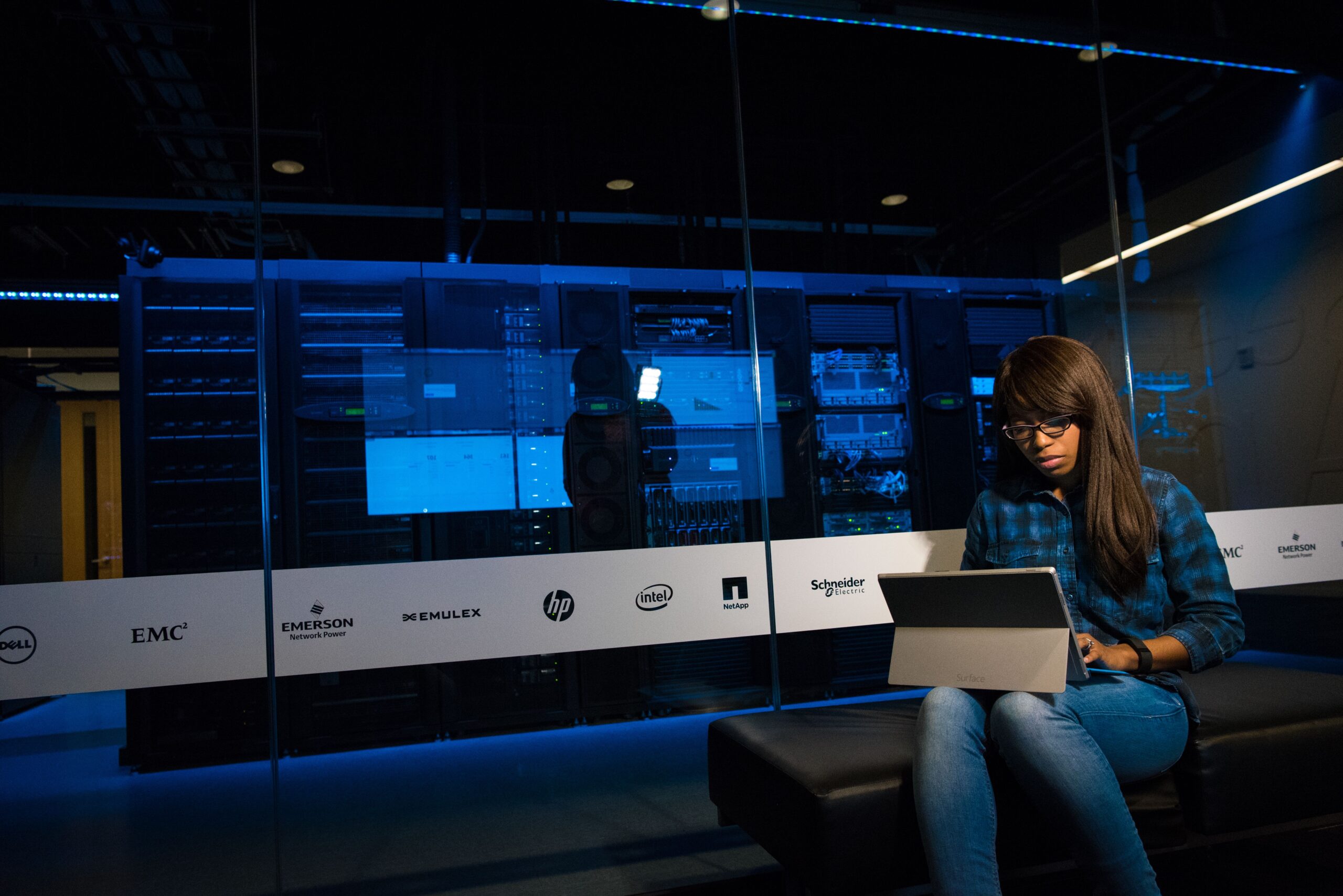 Insights Blog 1 IT professional working in a data center, illustrating the facility environments where cooling and humidity control directly affect PUE and equipment reliability