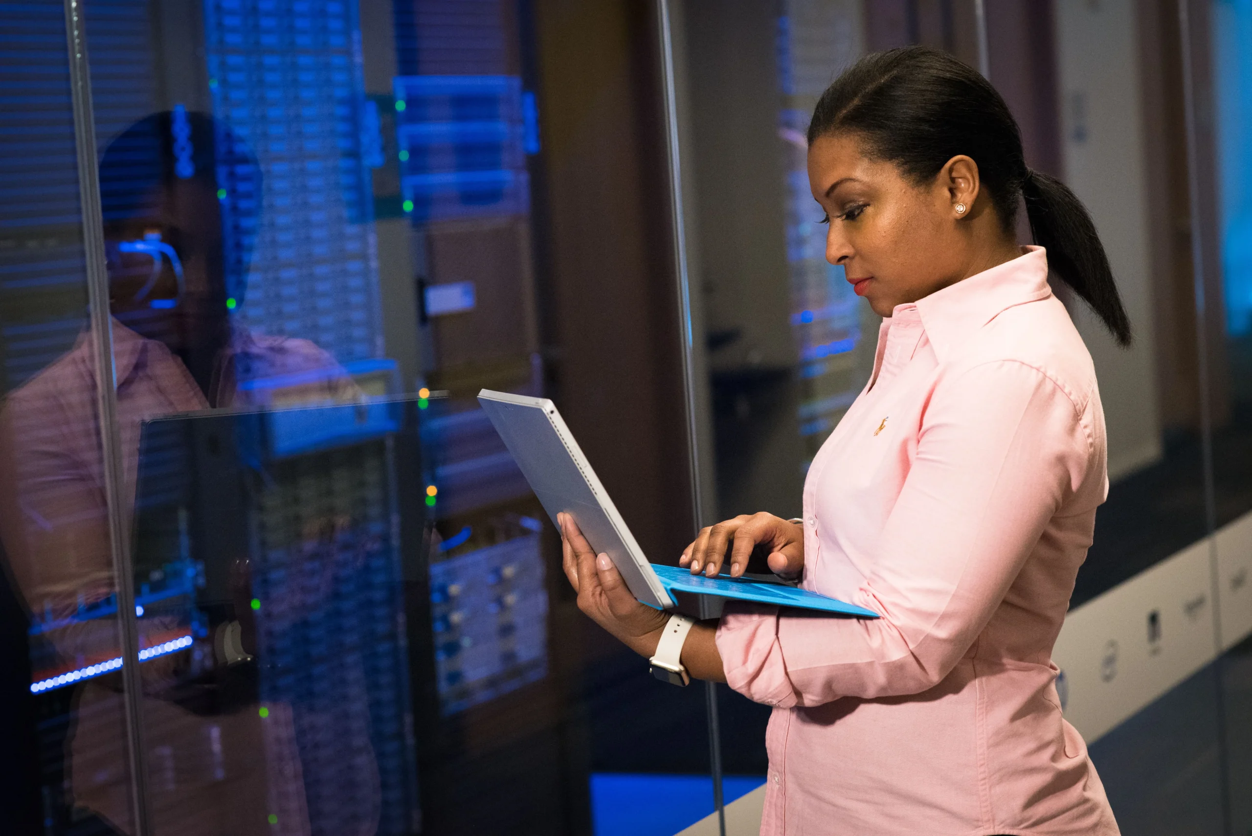 Insights Blog 1 Technician checking data on a laptop in a server room, supporting humidity monitoring and ESD risk management.