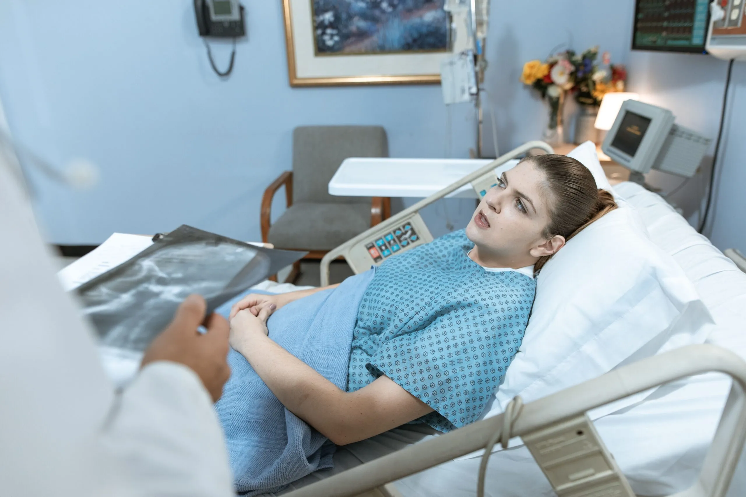 Doctor consulting with a patient in a hospital room, where humidity control supports recovery and reduces infection risk.